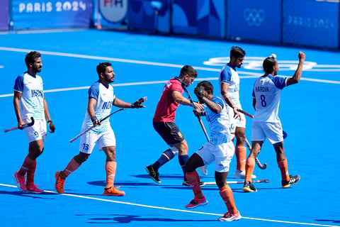 India's players celebrate after winning the men's bronze medal field hockey match against Spain